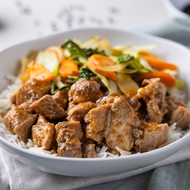 Side shot of Sticky Plum Pork, showcasing the same elements as the previous photos, emphasizing the layers of texture and color in the dish.