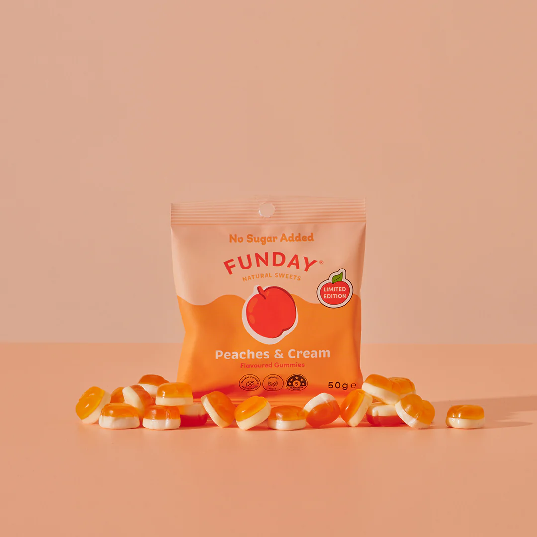 The Funday Sweets Peaches and Cream is in an orange and peach colour packet with the peaches and cream lollies scattered in front of it.